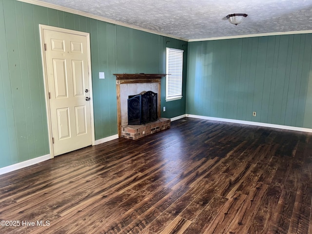 unfurnished living room featuring a fireplace, ornamental molding, dark hardwood / wood-style flooring, and a textured ceiling