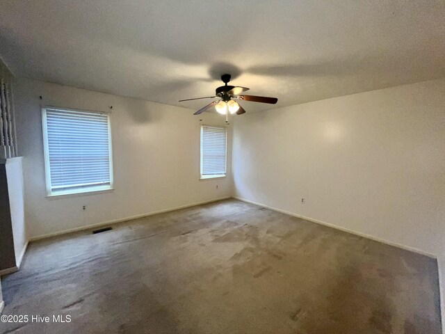 empty room with ceiling fan and light colored carpet