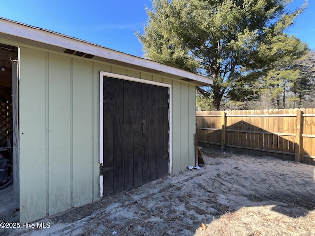 view of outbuilding with an outdoor structure and fence