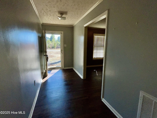 entryway featuring baseboards, visible vents, dark wood finished floors, a textured ceiling, and crown molding