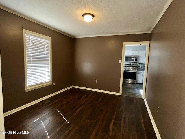 unfurnished room with ornamental molding, a textured ceiling, and dark hardwood / wood-style flooring