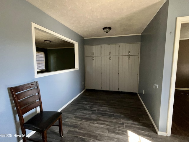 hall with a textured ceiling and dark hardwood / wood-style flooring