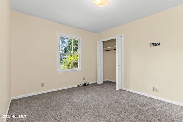 unfurnished bedroom with a closet and carpet flooring