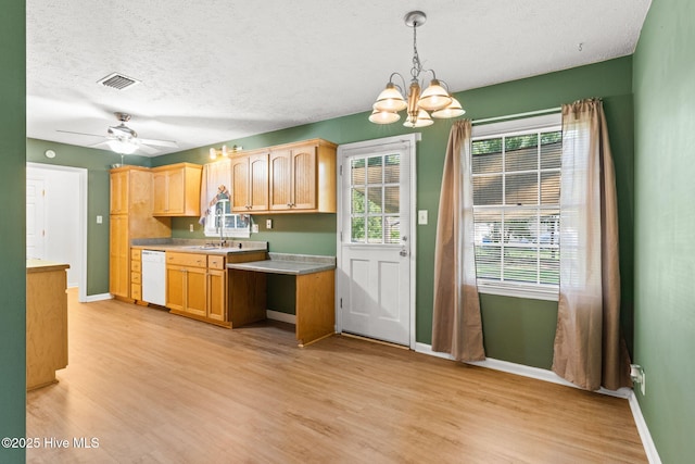 kitchen featuring ceiling fan with notable chandelier, pendant lighting, dishwasher, a textured ceiling, and light wood-type flooring