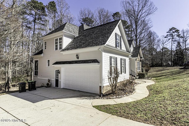 view of home's exterior featuring a garage, concrete driveway, and roof with shingles