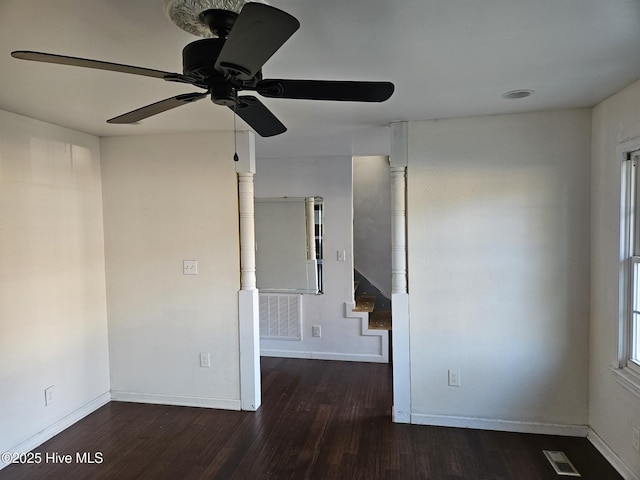 spare room featuring dark hardwood / wood-style flooring and ceiling fan