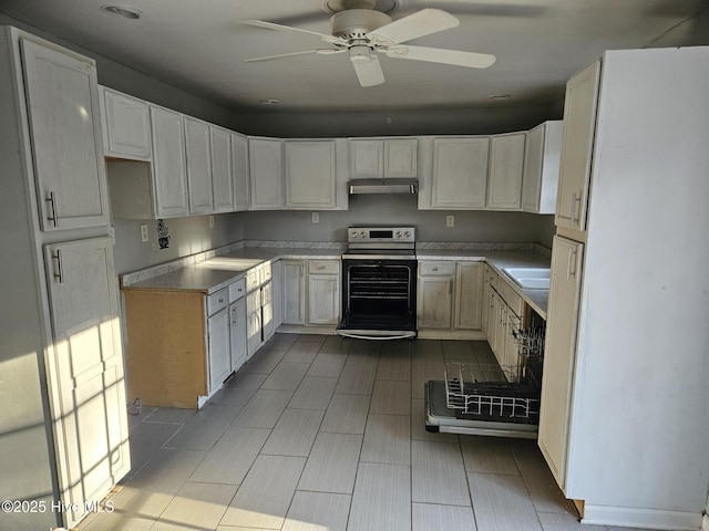 kitchen with white cabinetry, sink, electric range, and ceiling fan