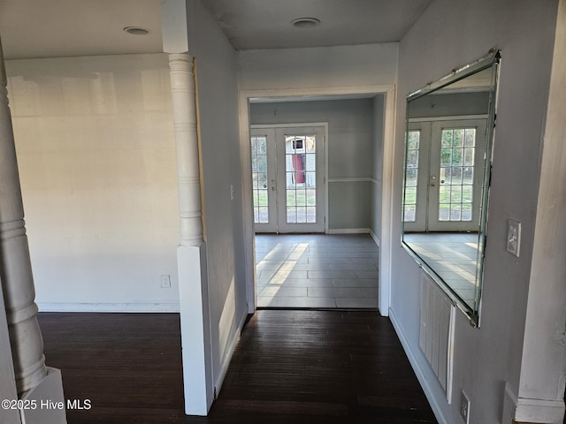 hall featuring french doors, plenty of natural light, and dark hardwood / wood-style floors