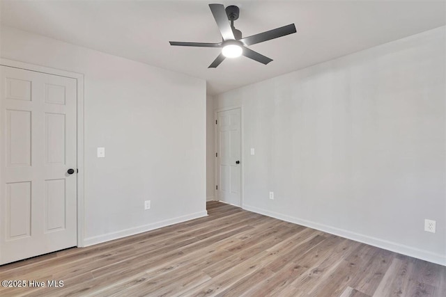 empty room with light wood-style flooring, baseboards, and a ceiling fan