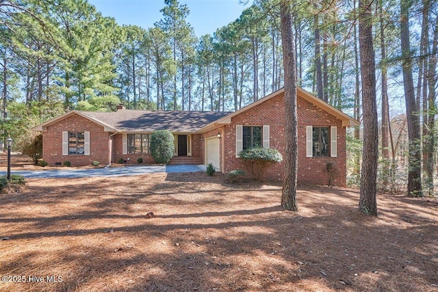 ranch-style house with a garage, crawl space, a chimney, and brick siding