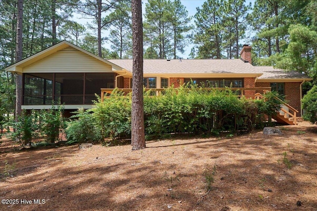 111 Forest Square Ln, West End, NC 27376 - ranch-style home with a sunroom, brick siding, stairway, a chimney, and roof with shingles