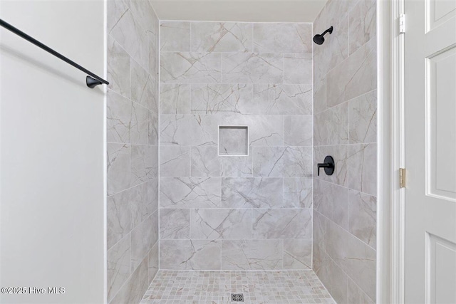 full bath with a tile shower