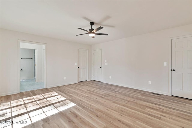 empty room with light wood-style flooring, baseboards, and a ceiling fan