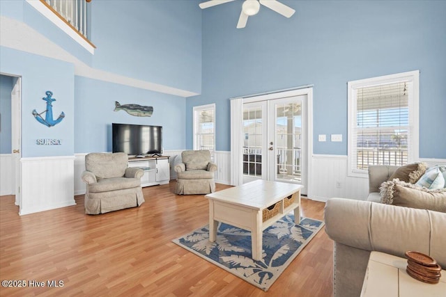 living room with french doors, ceiling fan, and hardwood / wood-style floors