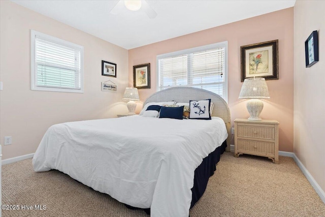 carpeted bedroom with multiple windows and ceiling fan