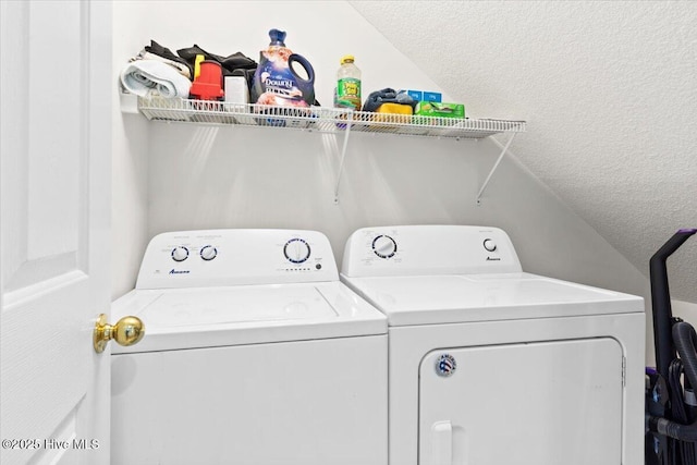 laundry room featuring washing machine and dryer and a textured ceiling