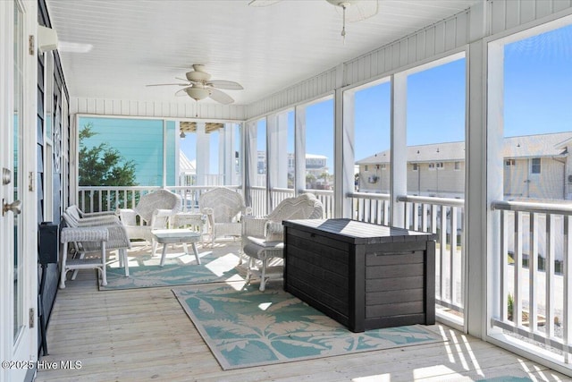 sunroom featuring ceiling fan