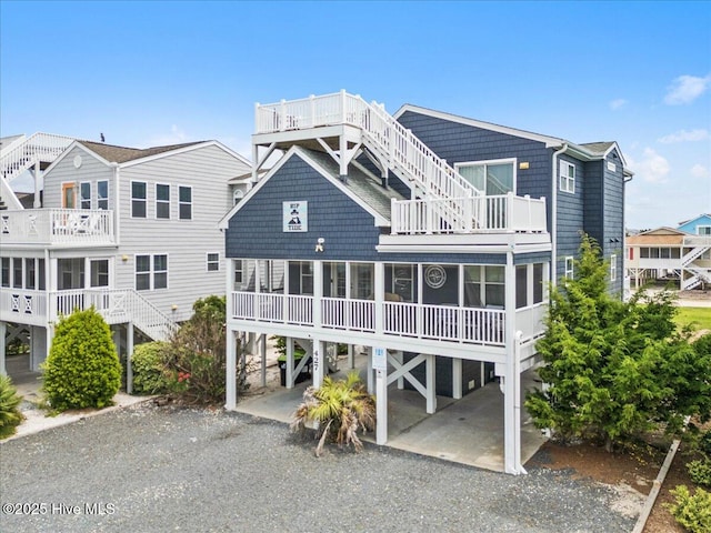 rear view of house with a carport and a balcony