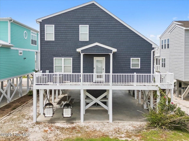 rear view of house featuring a wooden deck