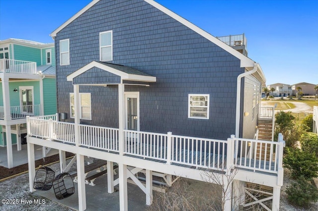 rear view of property featuring a balcony