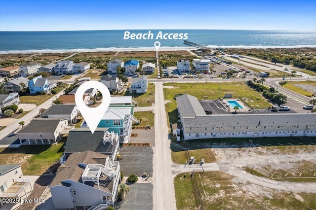 birds eye view of property with a beach view and a water view