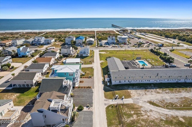 bird's eye view featuring a view of the beach and a water view