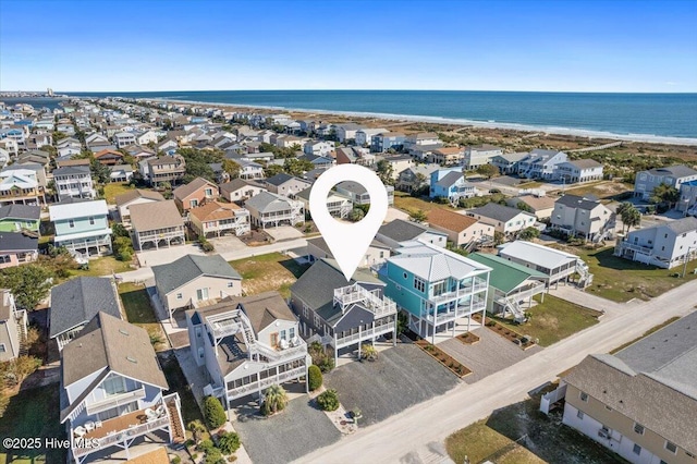 drone / aerial view with a water view and a beach view