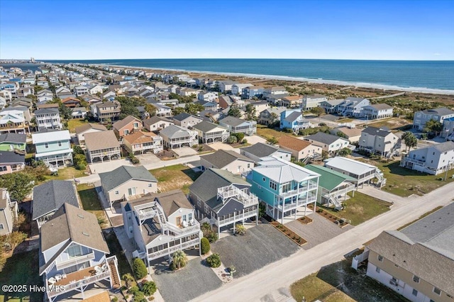 birds eye view of property with a water view and a view of the beach