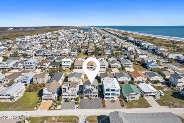 drone / aerial view with a water view and a view of the beach