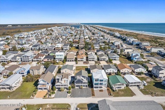 birds eye view of property featuring a water view and a view of the beach