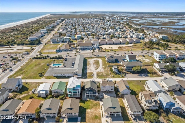 drone / aerial view with a water view and a view of the beach