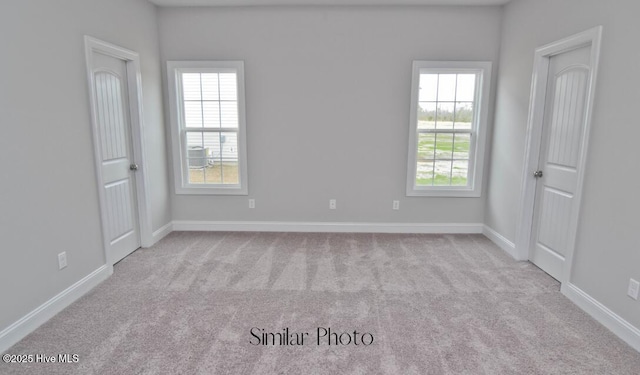 spare room featuring light colored carpet