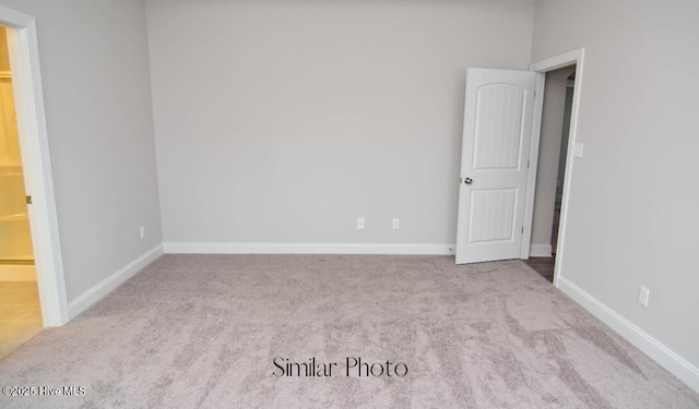 unfurnished room featuring light colored carpet