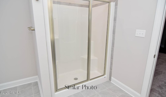 bathroom featuring tile patterned flooring and a shower with door