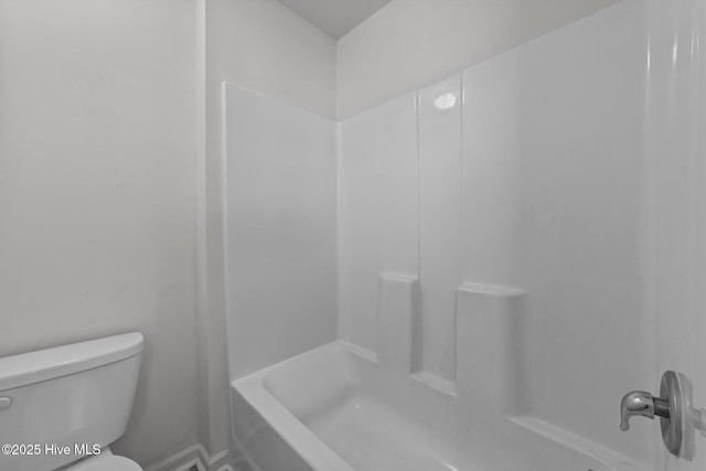 bathroom featuring bathtub / shower combination and toilet