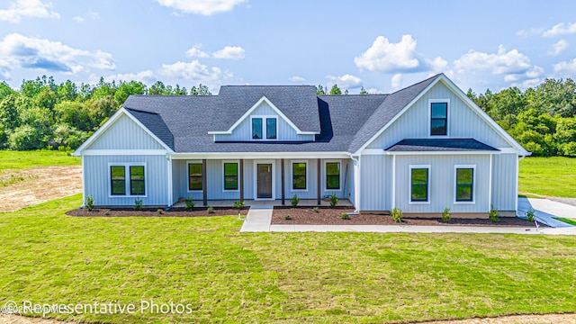 modern farmhouse featuring a front yard and covered porch