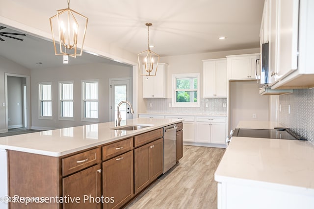 kitchen with hanging light fixtures, white cabinetry, and an island with sink