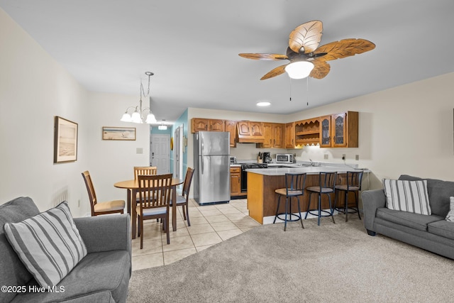 living room with sink, ceiling fan with notable chandelier, and light tile patterned flooring