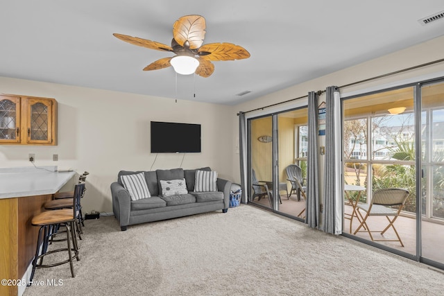 carpeted living room featuring ceiling fan