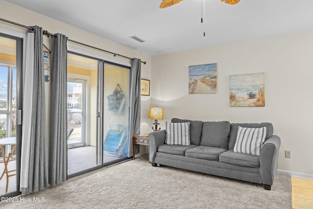 living room featuring carpet flooring, a wealth of natural light, and ceiling fan