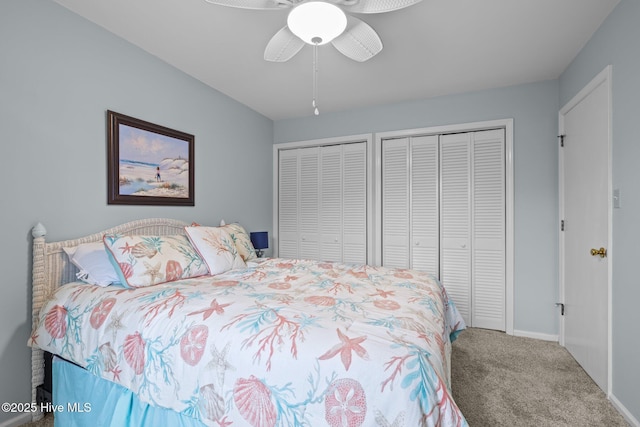 carpeted bedroom featuring multiple closets and ceiling fan