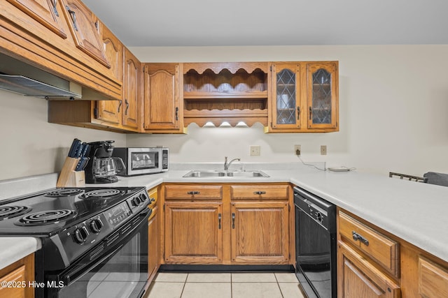 kitchen with sink, light tile patterned floors, custom exhaust hood, and black appliances