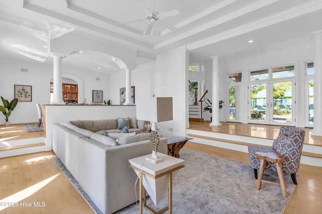 living area with light wood-style flooring, decorative columns, and recessed lighting