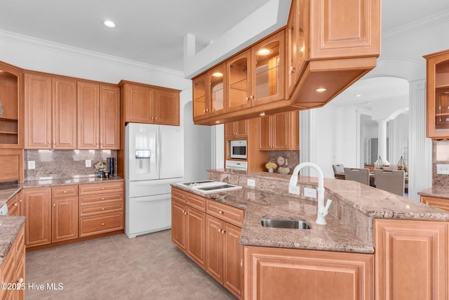 kitchen featuring ornate columns, a sink, open shelves, white appliances, and tasteful backsplash
