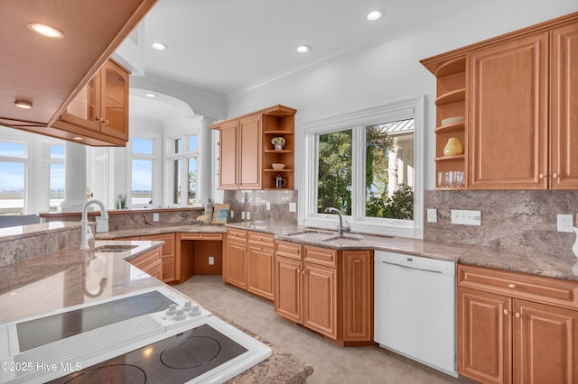 kitchen with open shelves, dishwasher, arched walkways, and a sink