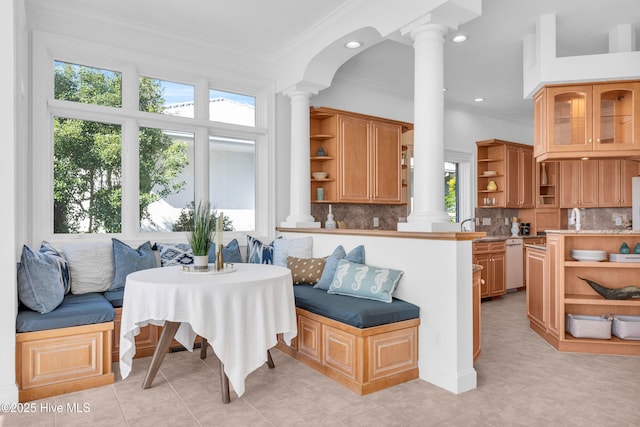 interior space featuring ornamental molding, breakfast area, recessed lighting, and decorative columns