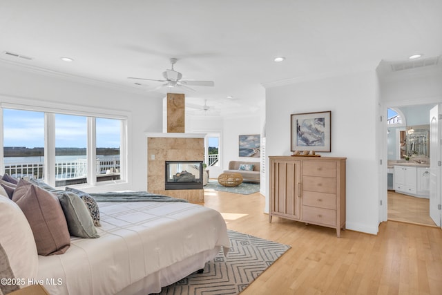 bedroom with ornamental molding, visible vents, and multiple windows