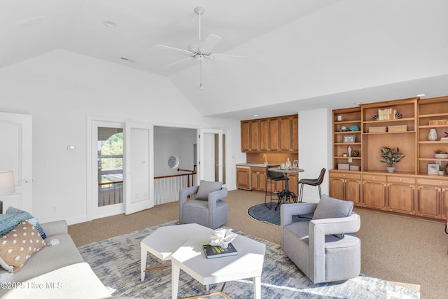 living room with ceiling fan, high vaulted ceiling, and light colored carpet