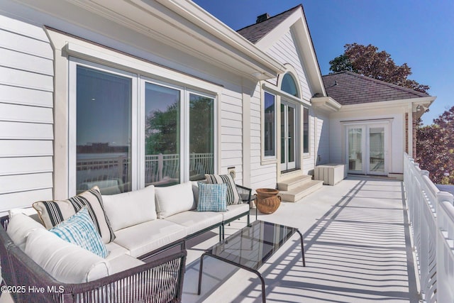 wooden terrace with an outdoor hangout area, entry steps, a patio area, and french doors