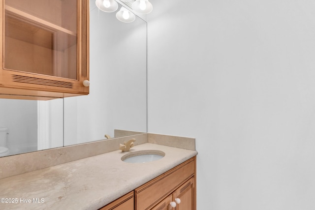 bathroom with toilet and vanity